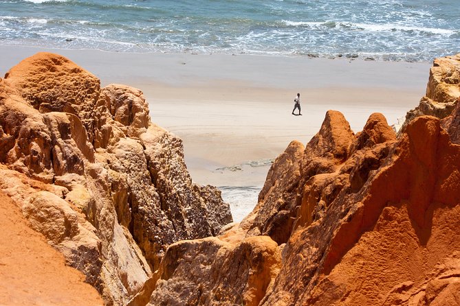 The colorful sands of Morro Branco beach - Full Day Tour - Entering Morro Branco’s red and white rock labyrinth